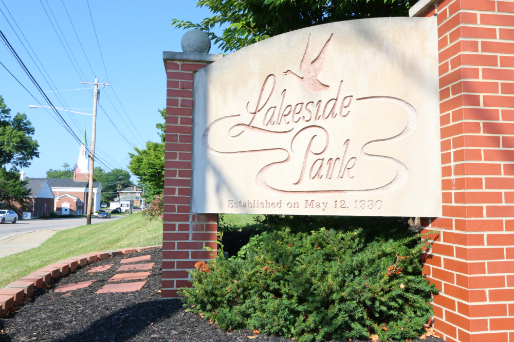 Lakeside Park | The Design Emporium Water tower with red and white stripes reading 'FLORENCE Y'ALL' against a cloudy sky.