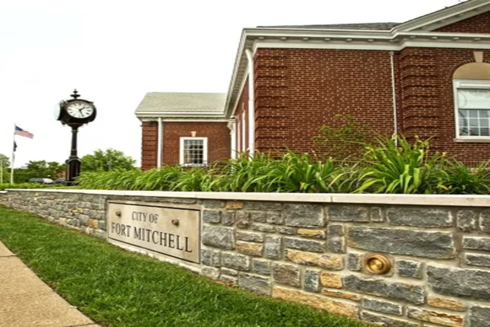 Fort Mitchell | The Design Emporium Water tower with red and white stripes reading 'FLORENCE Y'ALL' against a cloudy sky.