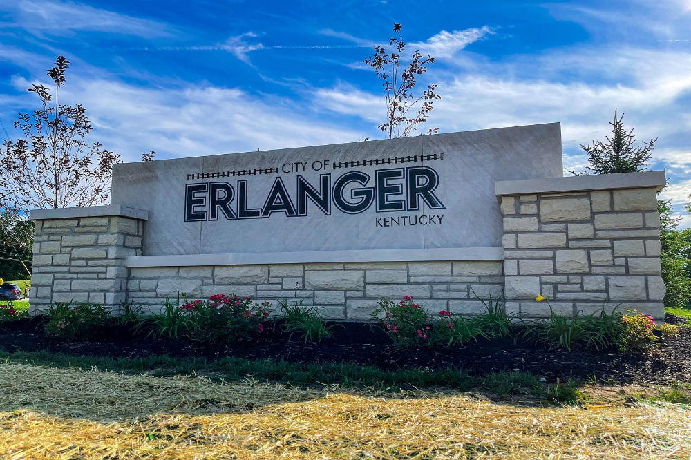 Erlanger Ky | The Design Emporium Water tower with red and white stripes reading 'FLORENCE Y'ALL' against a cloudy sky.