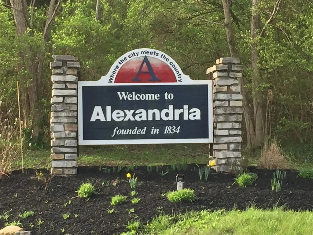 Alexandria KY | The Design Emporium Water tower with red and white stripes reading 'FLORENCE Y'ALL' against a cloudy sky.